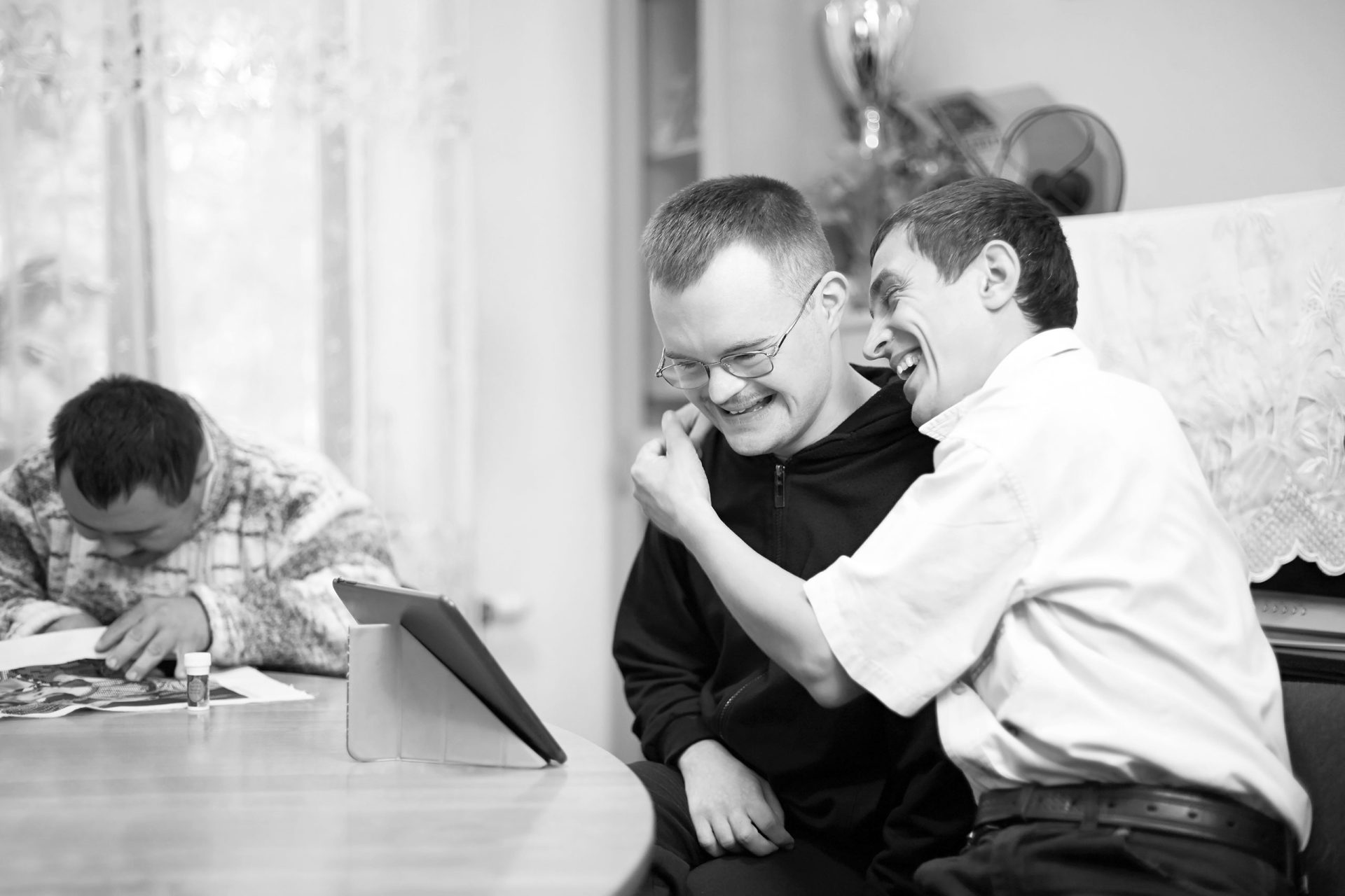 Two people looking at a tablet device